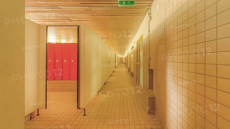 A corridor with tiled walls and doors on both sides leading to changing room lockers, Bad am Park, Lost Place, Essen, North Rhine-Westphalia, Germany, Europe