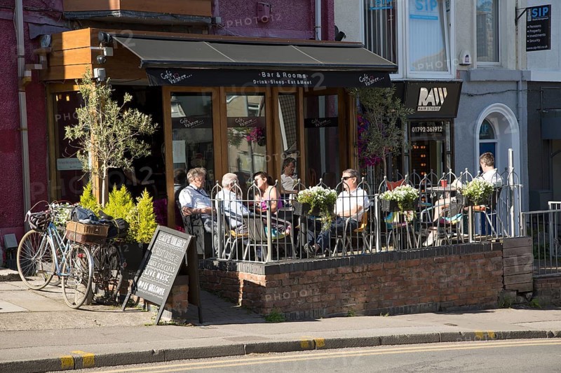 People sitting outside cafe bar, Oystermouth, Mumbles, Gower peninsula, near Swansea, South Wales, UK