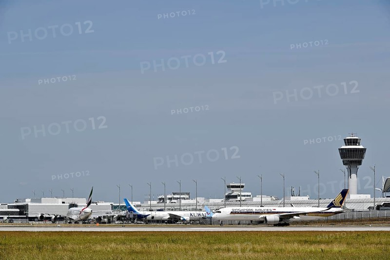 Heavy traffic with Singapore Airlines Airbus A350-900, Emirates Airways Airbus A380-800 and Kuwait Airlines at Terminal 1 with control tower, Munich Airport, Upper Bavaria, Bavaria, Germany, Europe