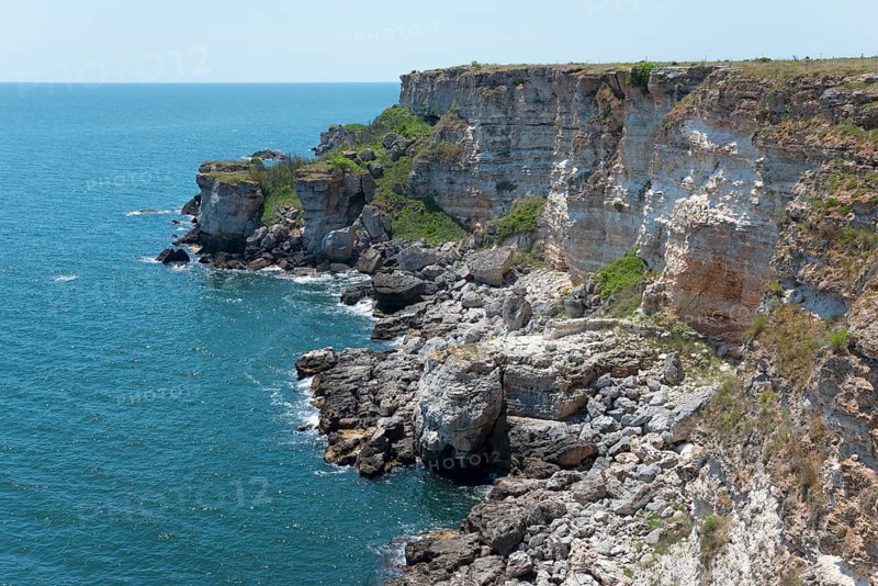 Picturesque cliffs with eroded rock formations on the edge of the sapphire blue sea, cliffs, Kamen Bryag, Bryag, stone shore, Dobrich, Bulgaria, Europe