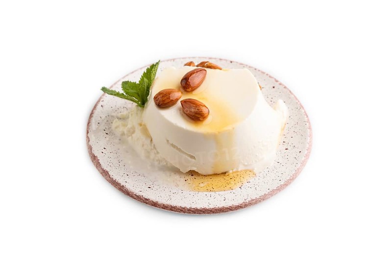 Ricotta cheese with honey and almonds isolated on white background. side view, close up