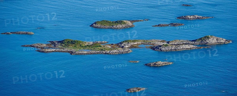 Rocky islands in the blue sea, sea with archipelago islands, Ulvagsundet, Vesteralen, Norway, Europe