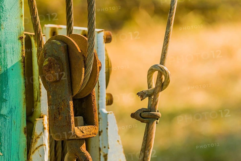 Closeup of a rusty pulley assembly with a blurred background in South Korea