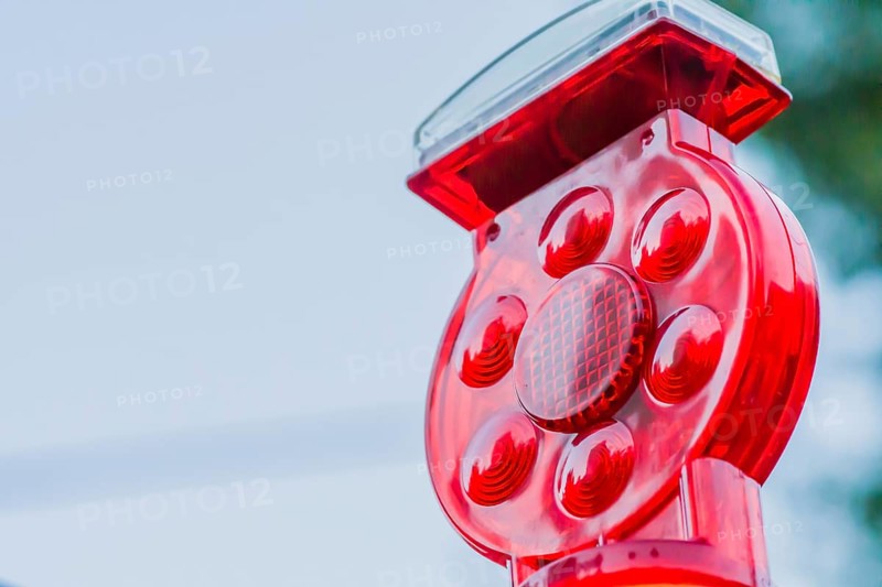 Closeup of red warning reflector against blurred background