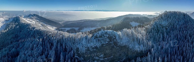 View over the first Jura chain with Belchenflueh in winter into the Central Plateau with high fog, behind it Alpine panorama, drone shot, Haegendorf, Solothurn, Switzerland, Europe