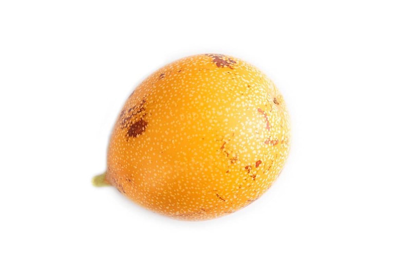 Granadilla isolated on white background. Top view, flat lay. Tropical, healthy food, summer, exotic, minimalism