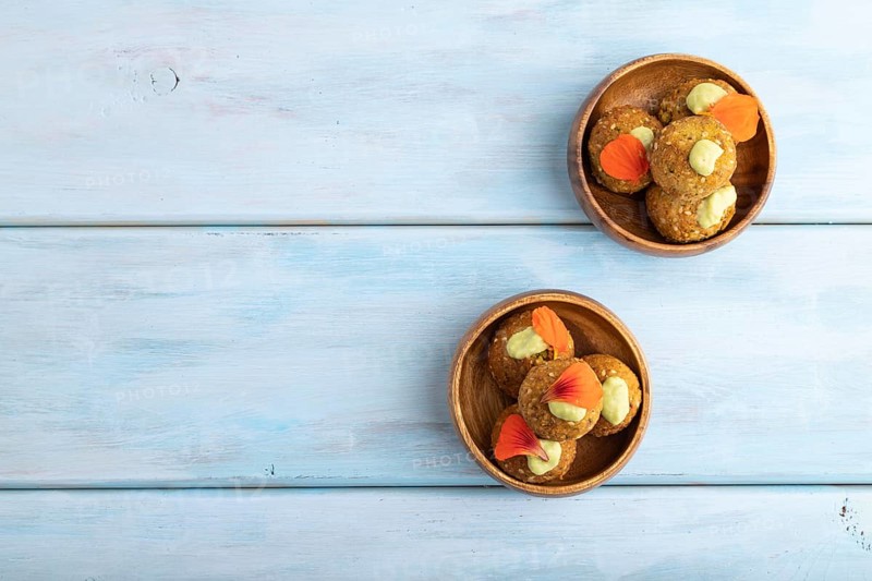 Falafel with guacamole on blue wooden background. Top view, flat lay, copy space