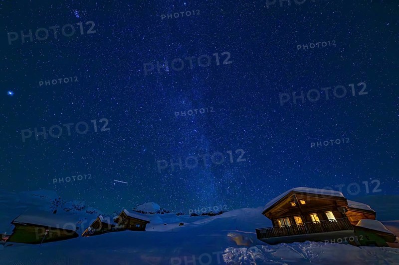 Mountain huts at night under a clear starry sky with illuminated windows in winter, Belalp, Naters, Brig, Canton Valais, Switzerland, Europe