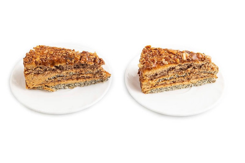 Walnut and hazelnut cake with caramel cream isolated on white background. side view