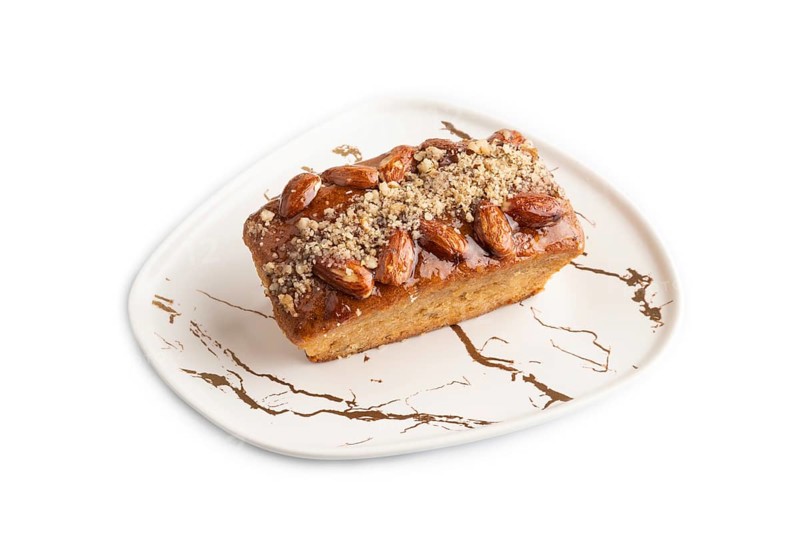 Caramel and almond cake isolated on white background. side view, close up