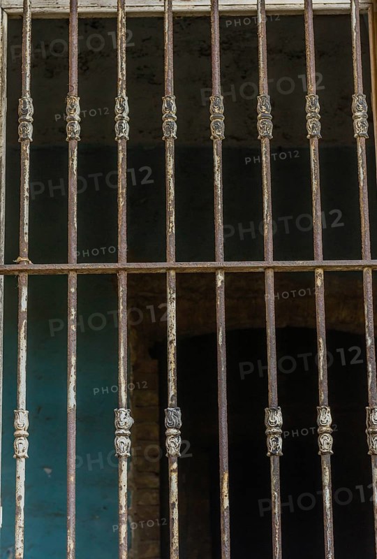 Bars over outside of glassless window in abandoned house in Istanbul, Tuerkiye