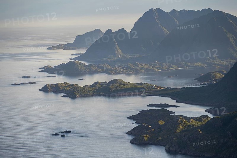 View of the coast in Ulvagsundet fjord and mountains in the evening light, Hurtigruten cruise ship in the fjord, view from the summit of Dronningsvarden or Stortinden, Vesteralen, Norway, Europe