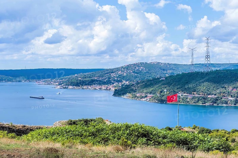 Bosporus Strait seen from hillside with ships and city buildings in background in Istanbul, Tuerkiye