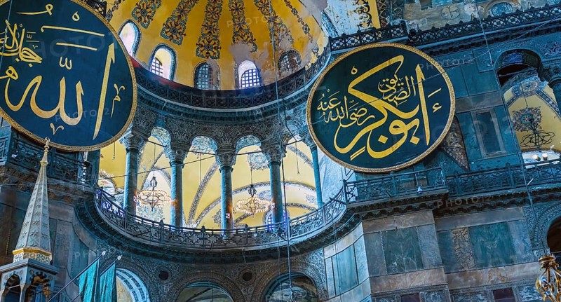 Medallions with Arabic script hanging on wall inside Hagia Sophia Mosque in Istanbul, Turkiye