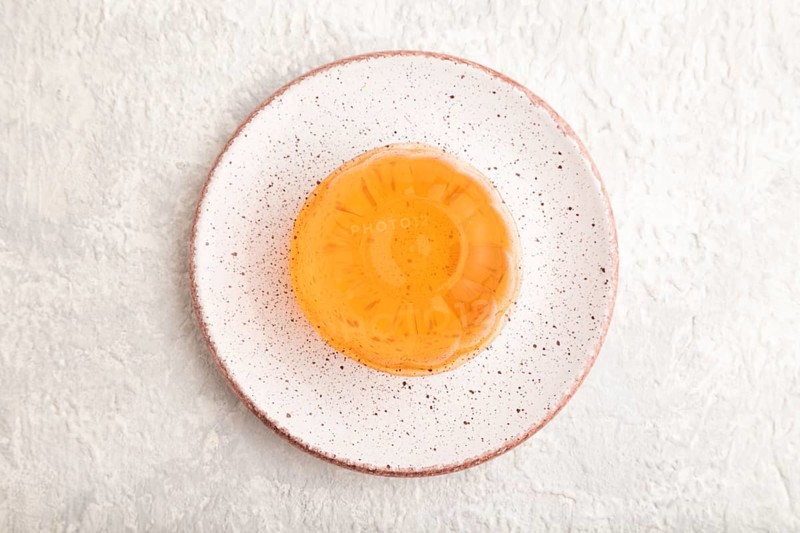 Papaya and orange jelly on gray concrete background. top view, flat lay, close up