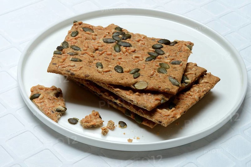 Crispbread with seeds on a plate, pumpkin seeds