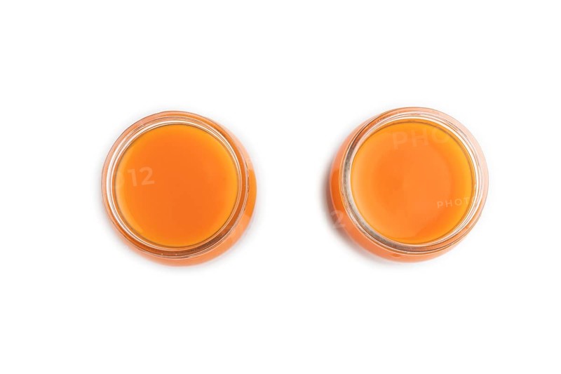 Baby puree with fruits mix, pumpkin, persimmon, mango infant formula in glass jar isolated on white background. Top view, flat lay, close up, artificial feeding concept