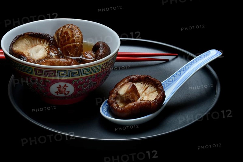 Dried shiitake mushrooms in a bowl, soaked in water