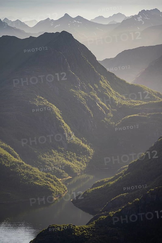 Fjord landscape with atmospheric evening light, Ulvagfjorden fjord and mountains, view from the top of Dronningsvarden or Stortinden, Vesteralen, Norway, Europe