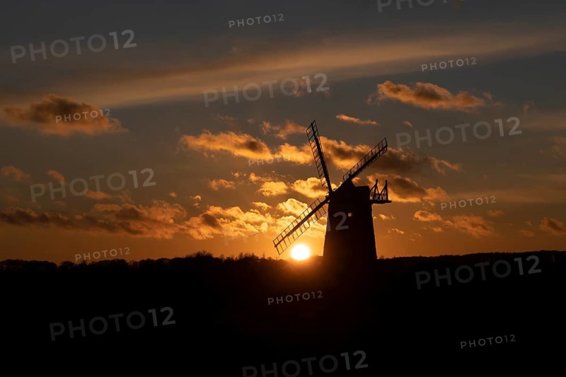 Windmill silhouetted at sunset with a red sky and clouds, Burnham Ovary Staithe, Norfolk, England, United Kingdom, Europe