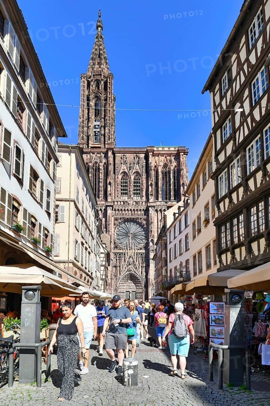 Strasbourg, France, September 5th 2023: Street with tourists in front of famous Strasbourg Cathedral in France in romanesque and gothic architecture style, Europe