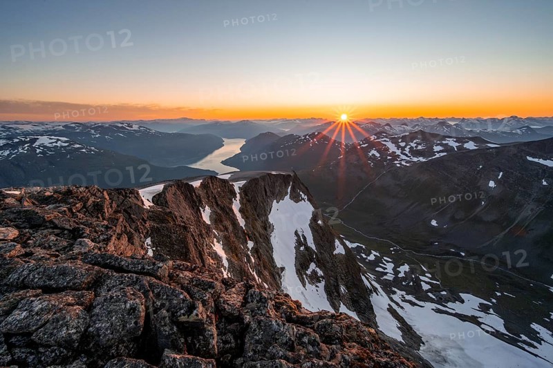 View of mountains and fjord Faleidfjorden, sun star at sunset, summit of Skala, Loen, Norway, Europe
