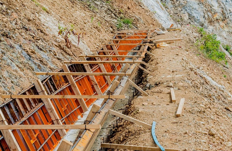 Construction form for man made drainage ditch on side of mountain