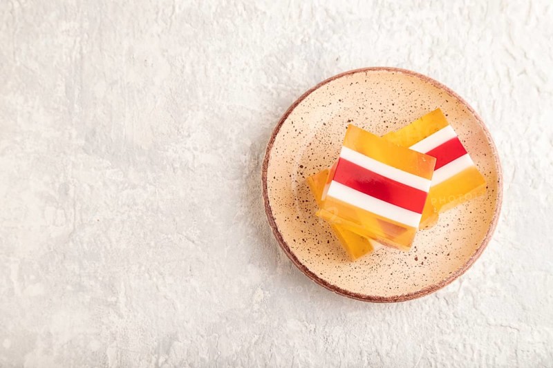 Almond milk and peach jelly on gray concrete background. top view, flat lay, copy space