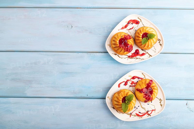 Semolina cheesecake with strawberry jam, lavender, on blue wooden background. top view, flat lay, copy space
