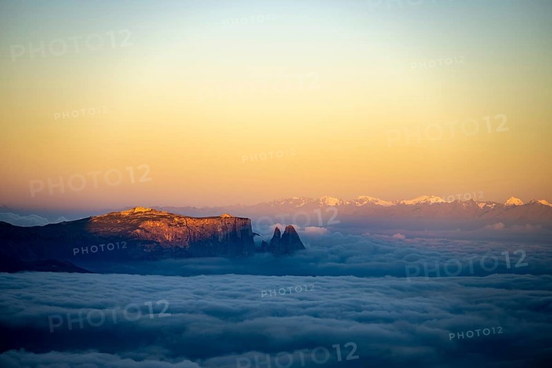 Sunrise over a sea of fog with the peaks of the Sella massif in the background, Corvara, Dolomites, Italy, Europe