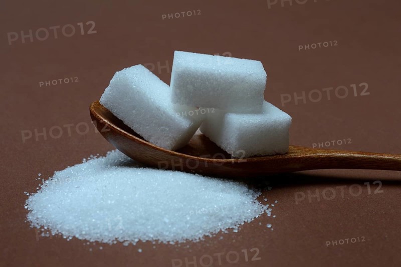 Granulated sugar and sugar cubes in spoons, sugar