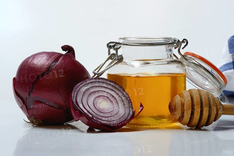 Honey in a jar and red onion, ingredients for cough syrup