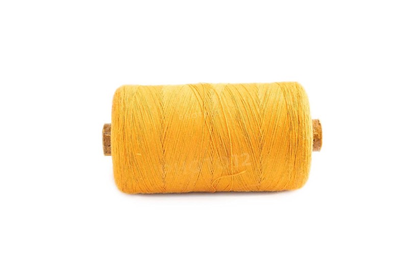 Spool of thread isolated on white background. Side view, close up