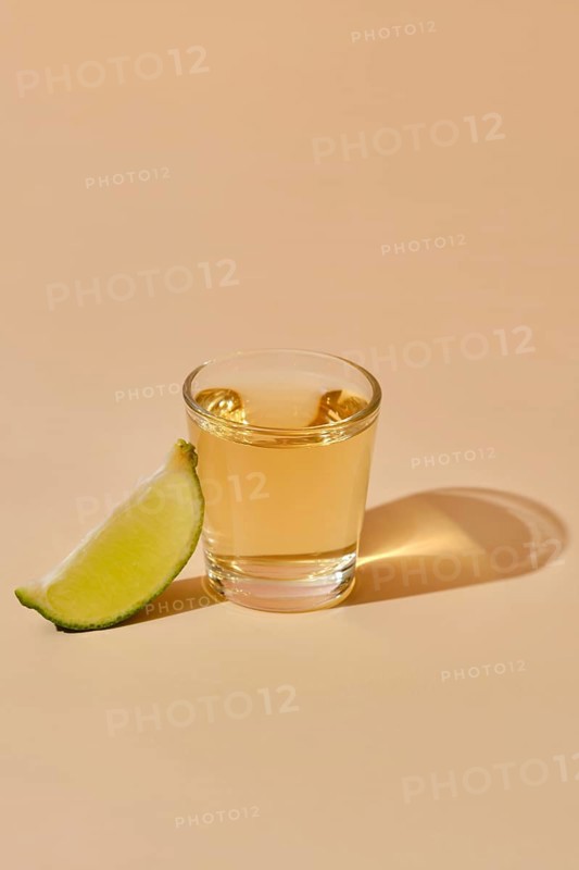 View from above on tequila shot with slice of lime