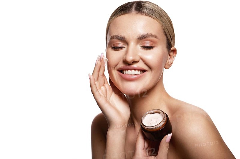 Beauty portrait of model with natural make-up holding a jar of cream. Fashion shiny highlighter on skin, sexy gloss lips make-up High quality photo