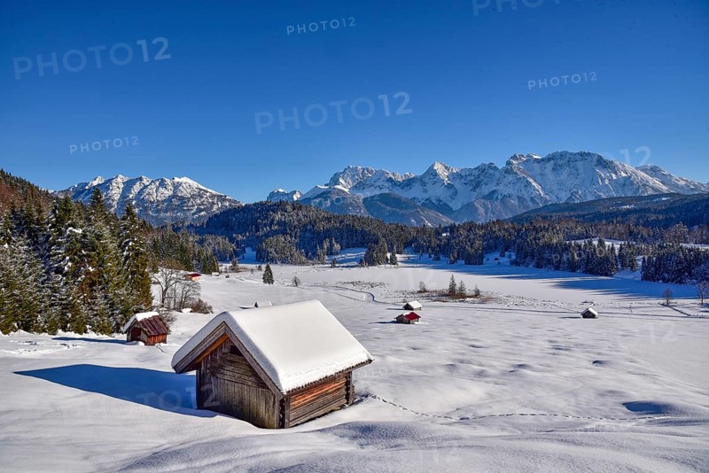 View of the frozen and snow-covered Geroldsee lake in Werdenfelser Land near Garmisch, with the Karwendel mountains in the background, Bavaria, Germany, Europe