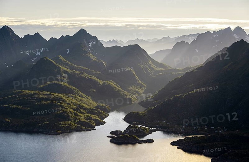 Mountains and fjord landscape with atmospheric evening light, Ulvagfjorden fjord and mountains, view from the top of Dronningsvarden or Stortinden, Vesteralen, Norway, Europe