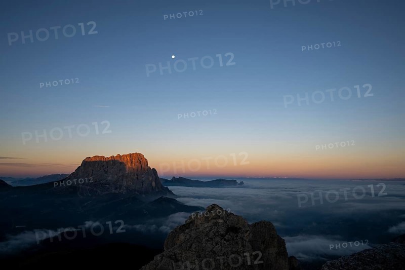 Sunrise over a sea of fog with the peaks of the Sella massif in the background, Corvara, Dolomites, Italy, Europe