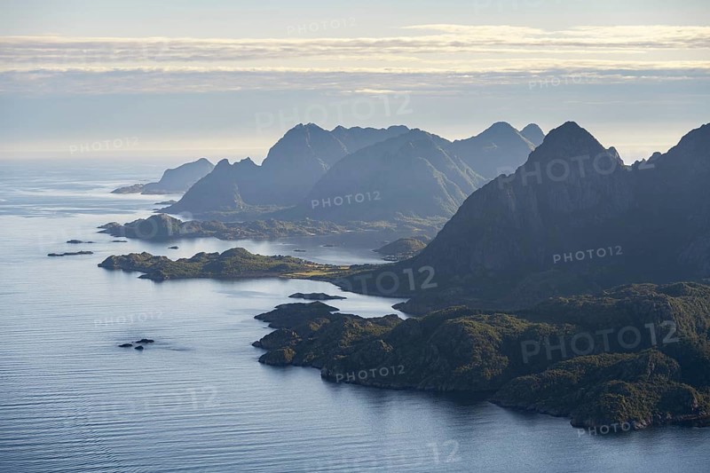 View of the coast in Ulvagsundet fjord and mountains in the evening light, view from the summit of Dronningsvarden or Stortinden, Vesteralen, Norway, Europe