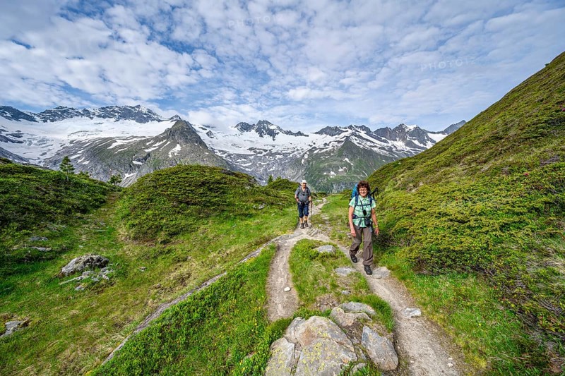 Two mountaineers on a hiking trail in a picturesque mountain landscape, mountain peaks with snow and glacier Hornkees and Waxeggkees, summit Grosser Moeseler and Hornspitzen, Berliner Hoehenweg, Zillertal Alps, Tyrol, Austria, Europe