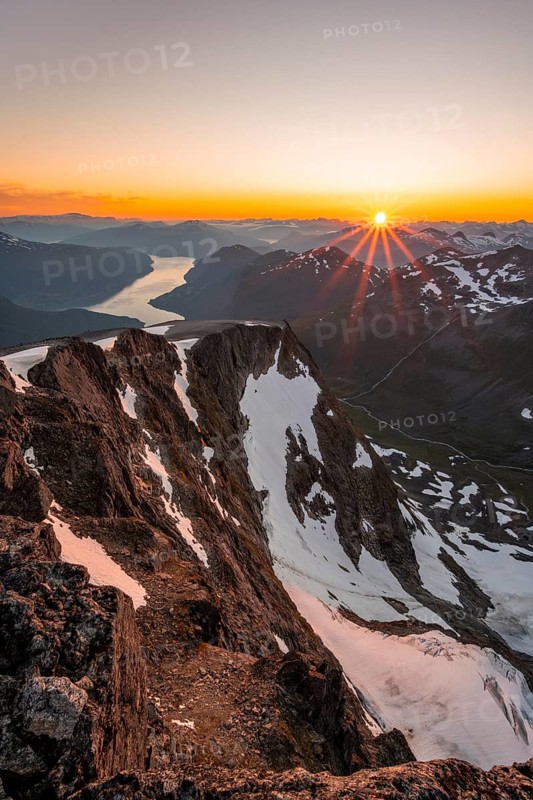 View of mountains and fjord Faleidfjorden, sun star at sunset, summit of Skala, Loen, Norway, Europe