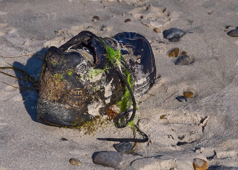 Stranded shoe on the beach in Houstrup, West Jutland, Denmark, Europe