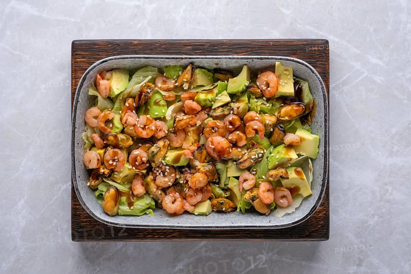 Top view of salad with shrimp, mussels and avocado