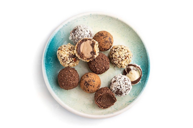 Chocolate truffle candies isolated on white background. top view, flat lay, close up
