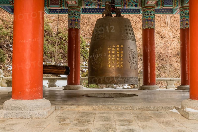 Giant brass bell in colorful pavilion at Guinsa temple in South Korea