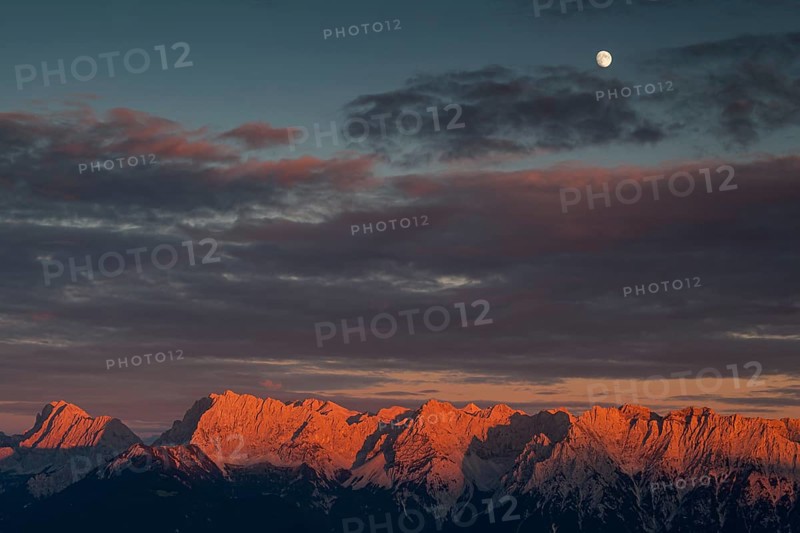 Distant view of steep mountains in the evening light, clouds, autumn, moon, view from Wank to Karwendel mountains, Werdenfelser Land, Upper Bavaria, Bavaria, Germany, Europe