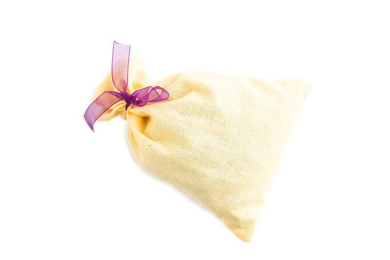 Yellow textile pouch isolated on white background. Top view, flat lay, close up