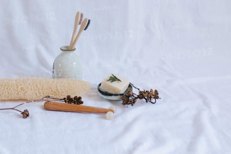 Eco-friendly personal care items with toothbrushes and soap dish on a white background, conveying a minimalistic and natural vibe