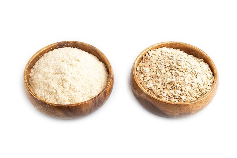 Powdered milk and oatmeal baby food mix, infant formula isolated on white background. Side view, artificial feeding concept