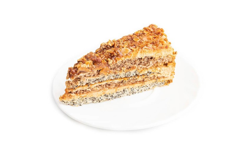 Walnut and hazelnut cake with caramel cream isolated on white background. side view